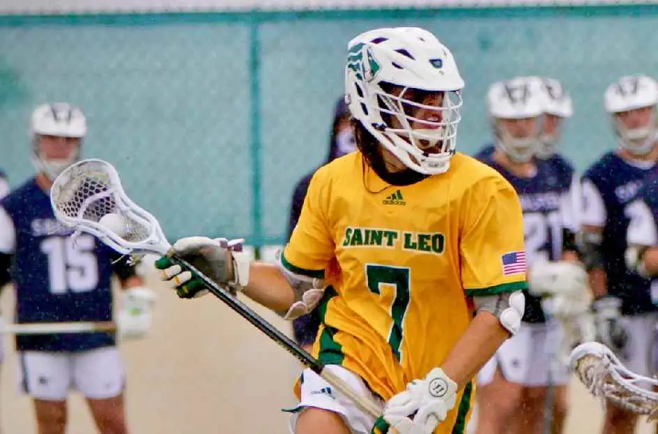 A lacrosse player in yellow and white uniform.