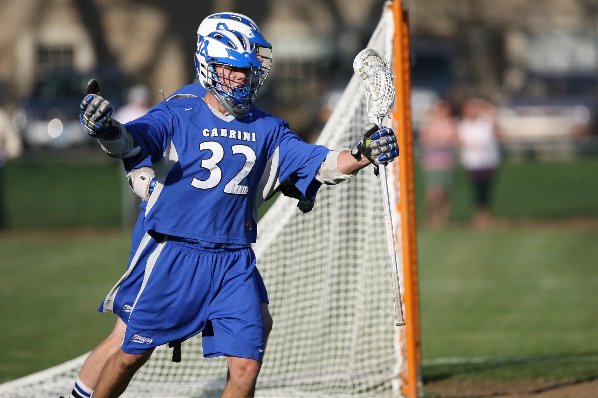 A lacrosse player in blue and white uniform.