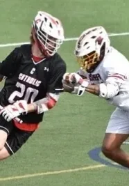 Two men playing lacrosse on a field.